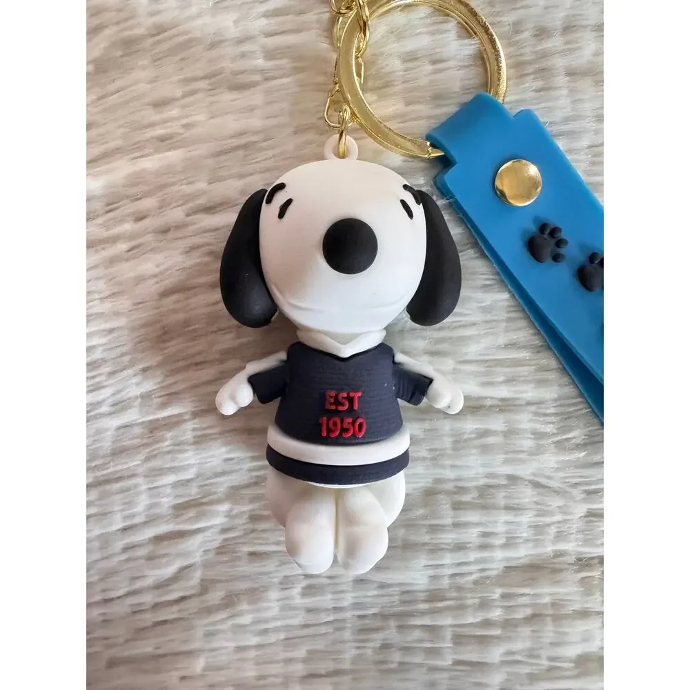 Snoopy with sweater keychain blue strap featuring white text and Snoopy graphic